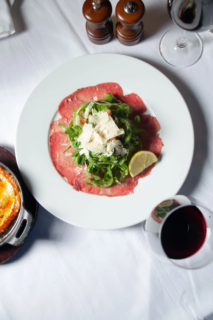 Angus carpaccio with arugula and Parmigiano