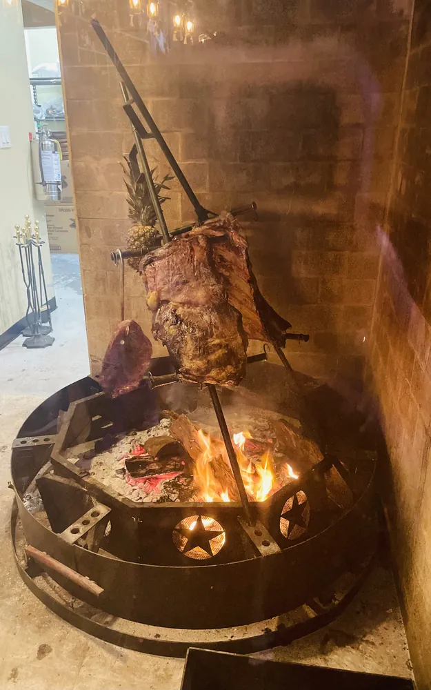 Meat roasting over the open fire pit